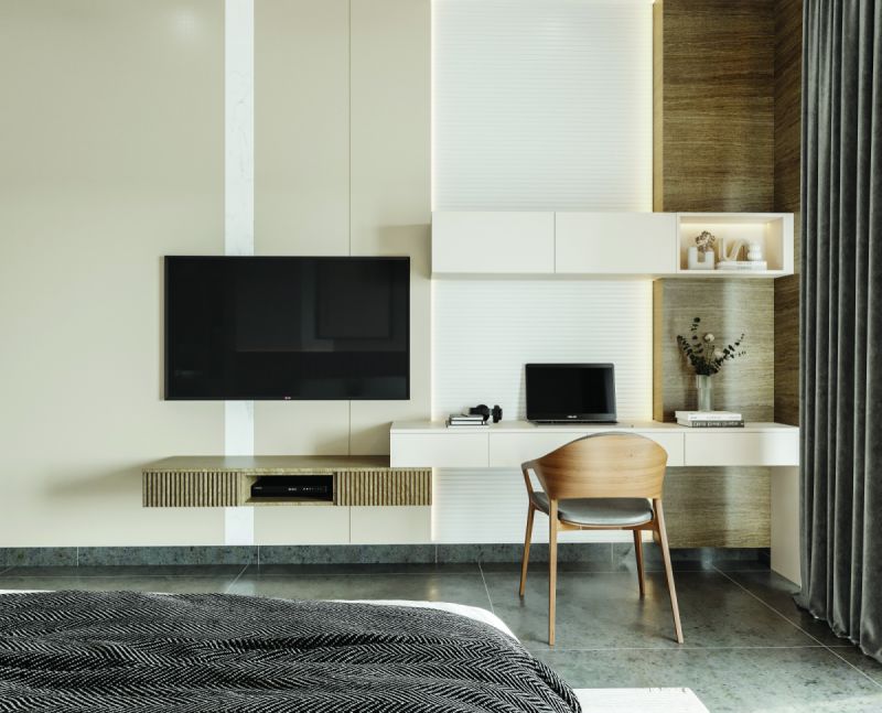 Bedroom with a wall-mounted TV unit and a study desk in a 3 BHK home in Hosur, designed by Huma Interiors