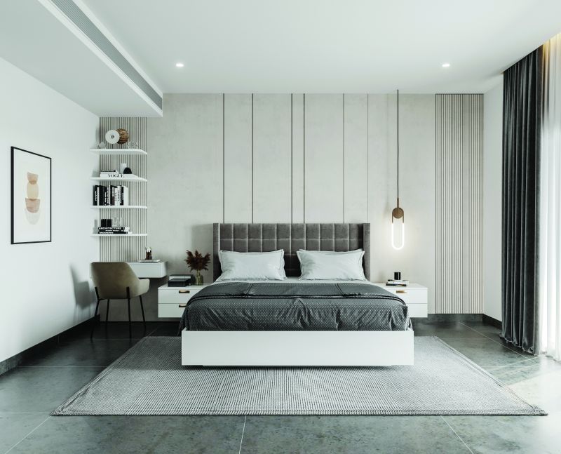 Bedroom with a grey upholstered bed and white wall panelling in a 3 BHK home in Hosur, designed by Huma Interiors