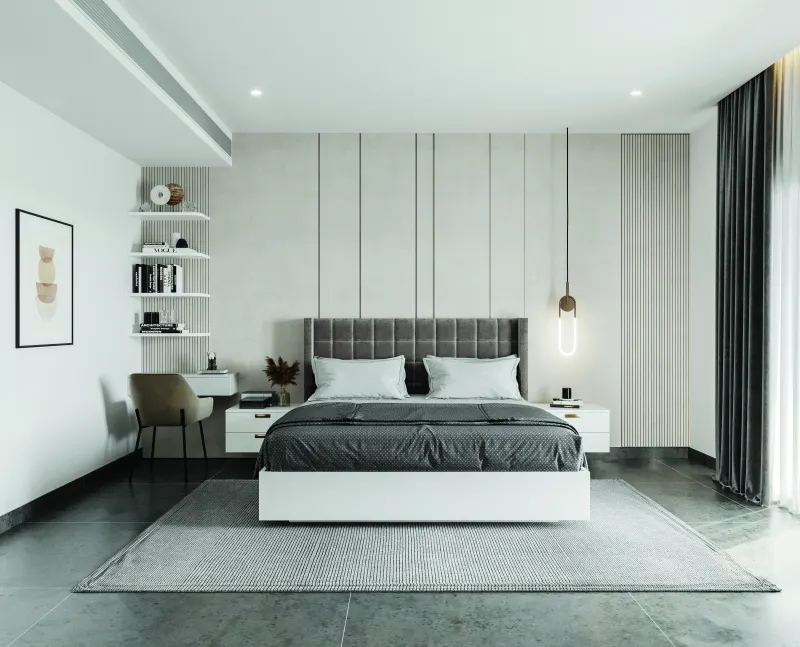 Bedroom with a grey upholstered bed and white wall panelling in a 3 BHK home in Hosur, designed by Huma Interiors