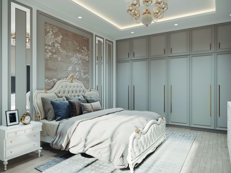 Bedroom with a full-height grey wardrobe and a classic headboard in a 2 BHK home in Chandapura, designed by Huma Interiors