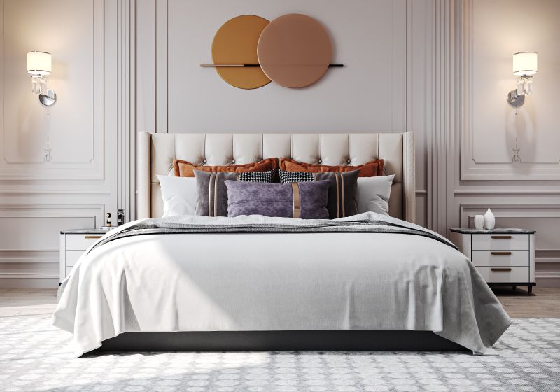 Bed against a white panelled headboard wall in a 2 BHK home in Chandapura, designed by Huma Interiors
