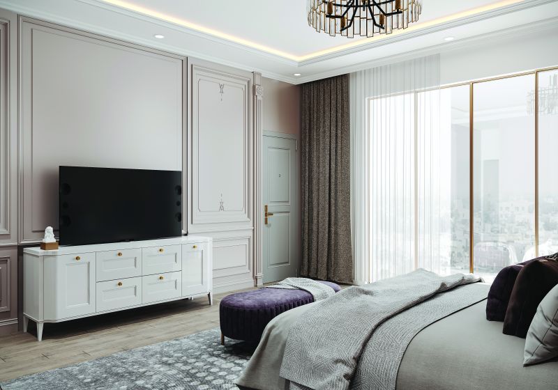 Bedroom TV wall with a white console and panelled walls in a 2 BHK home in Chandapura, designed by Huma Interiors