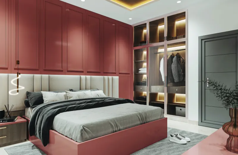 Bedroom with a deep red wardrobe and lit open shelves in a 2 BHK home in Bagaluru, designed by Huma Interiors
