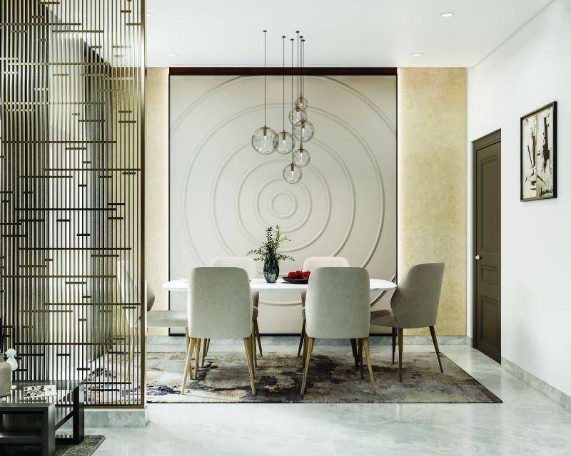 Dining area with a round wall feature and a metal partition screen in a 3 BHK home in Jigani, designed by Huma Interiors