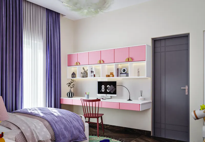 Study desk with pink shelves in a children’s room in a 3 BHK home in Jigani, designed by Huma Interiors