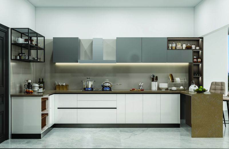 L-shaped modular kitchen in white and grey with a breakfast counter in a 3 BHK home in Jigani, designed by Huma Interiors
