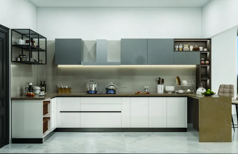 L-shaped modular kitchen in white and grey with a breakfast counter in a 3 BHK home in Jigani, designed by Huma Interiors